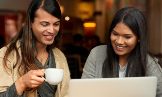 Image of two people looking at a laptop